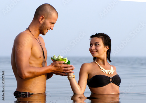 Closeup portrait of a happy young couple in sea