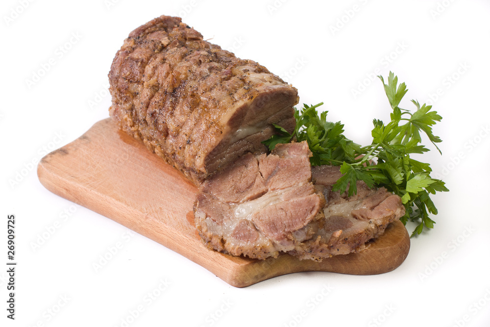 Appetizing piece of roasted meat on a wood piece with parsley Appetizing piece of roasted meat on a wood piece with parsley