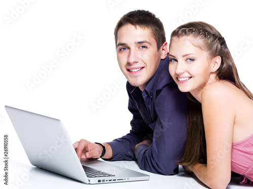 Portrait of happy young couple with laptop