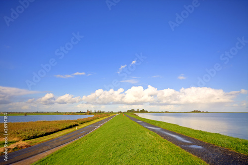 Typical dutch landscape: Water, dykes and wideness photo