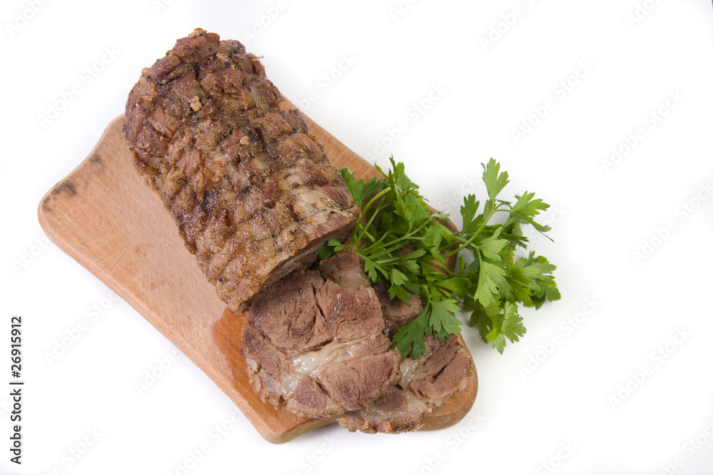 Appetizing piece of roasted meat on a wood piece with parsley Appetizing piece of roasted meat on a wood piece with parsley