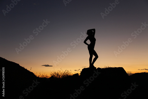 Sensual silhouette in the desert at sunset