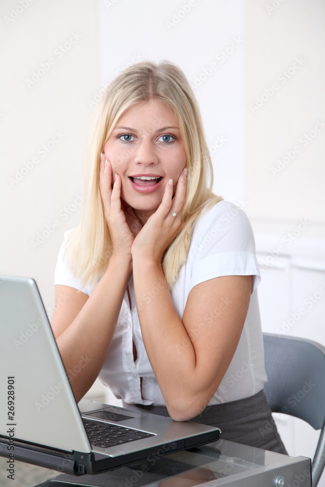 Blond businesswoman doing funny faces in the office Blond businesswoman doing funny faces in the office