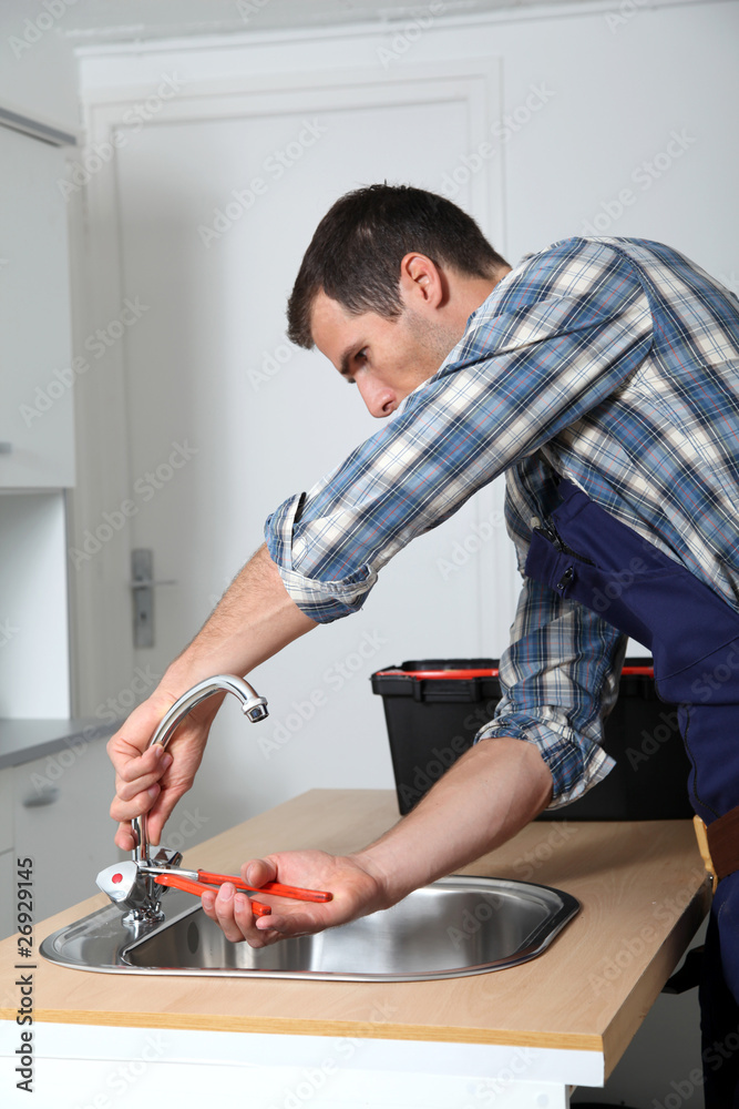 Plumber fixing domestic sink Plumber fixing domestic sink