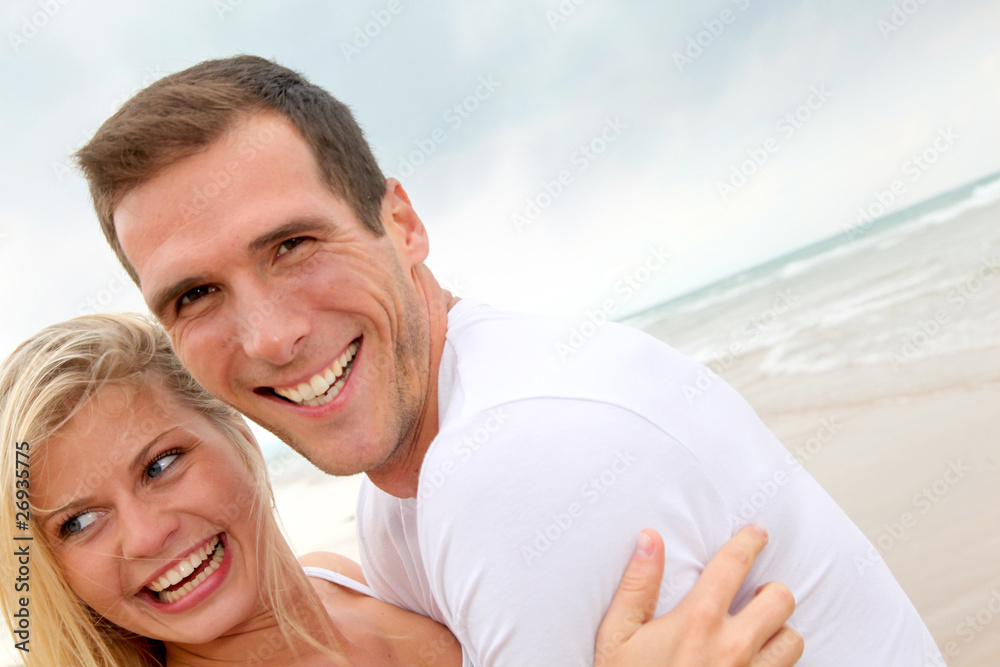 Fototapeta premium Couple having fun on a sandy beach