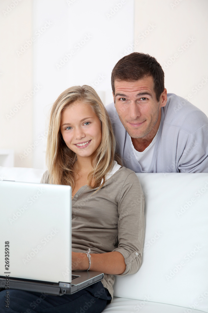 Father and child at home looking at internet Father and child at home looking at internet