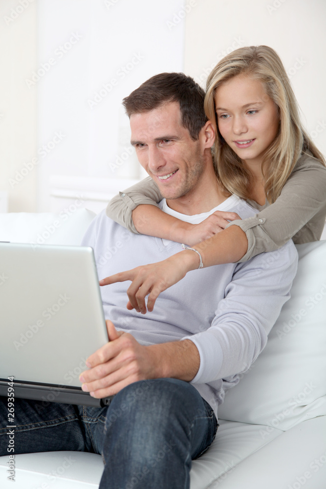 Father and child at home looking at internet Father and child at home looking at internet