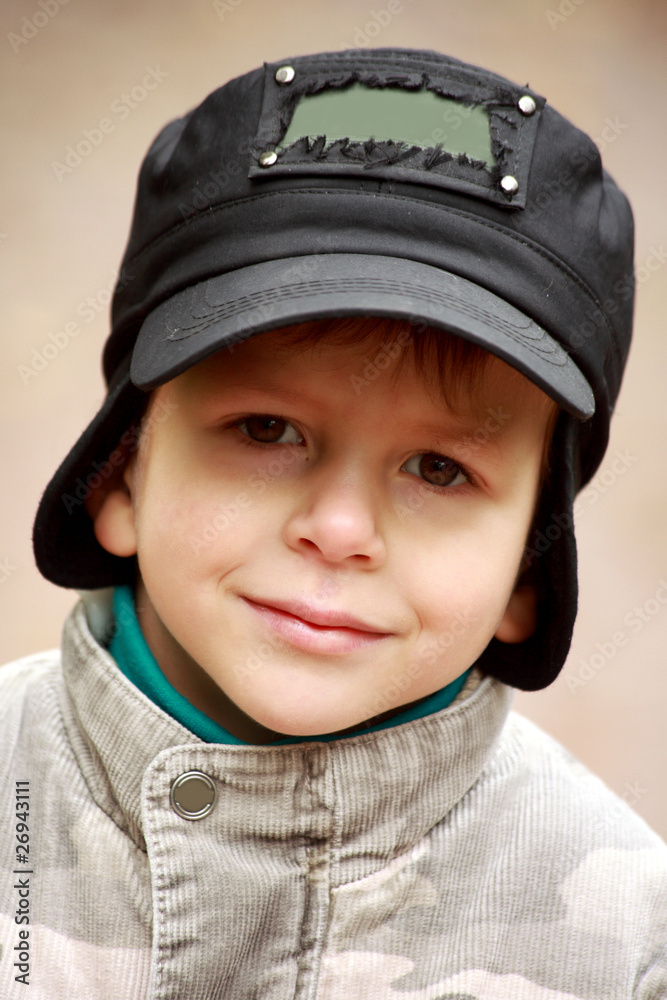 Portrait of a smiling little boy in hat