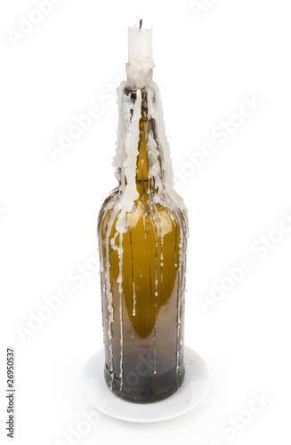 A candle stuck in a bottle photo