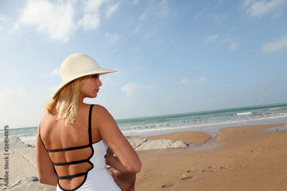 Woman sitting on a sandy beach Woman sitting on a sandy beach