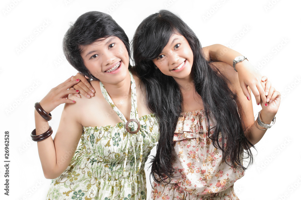 Two girl best friends smiling over white background Two girl best friends smiling over white background
