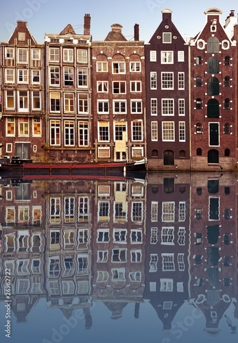 typical amsterdam houses reflected in the canal