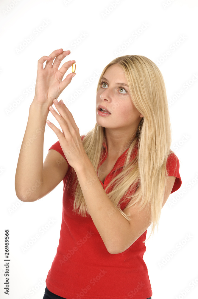 Fototapeta premium Blonde attraktive Frau mit Pille