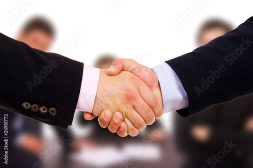 Closeup of business people shaking hands at the office