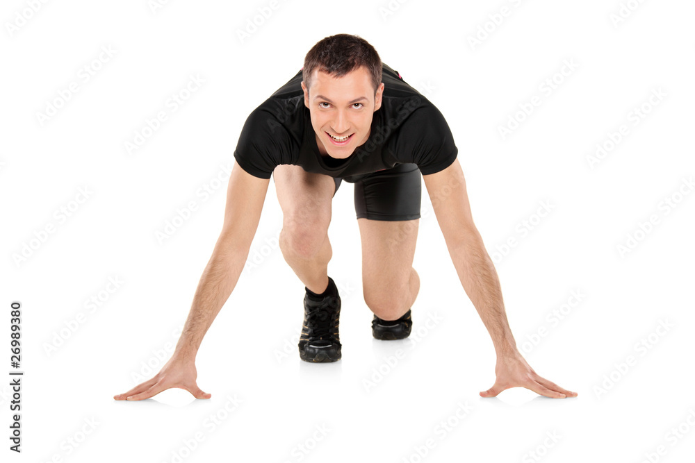 Full length portrait of a smiling male athlete ready to run Full length portrait of a smiling male athlete ready to run
