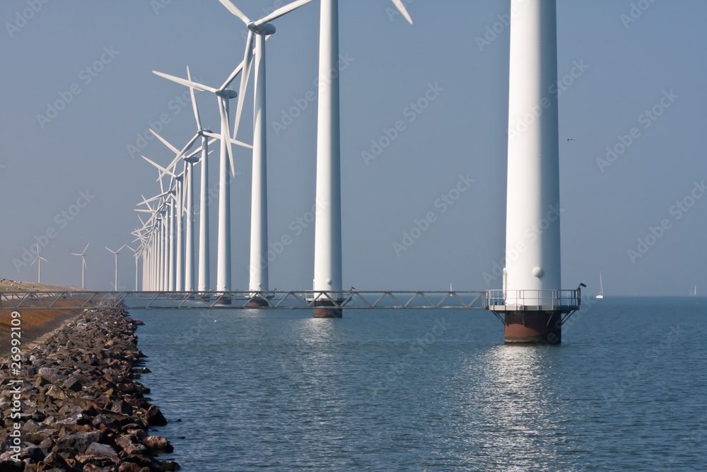 Row of windmills standing in Dutch sea