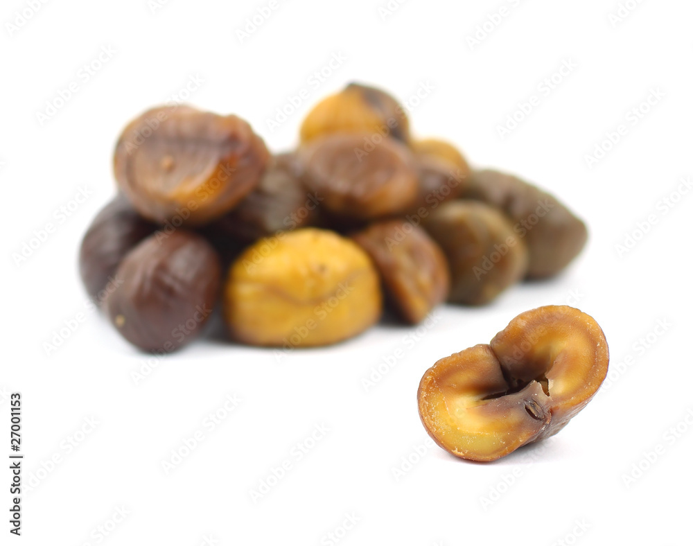 Single roasted chestnut with group of chestnuts behind Single roasted chestnut with group of chestnuts behind