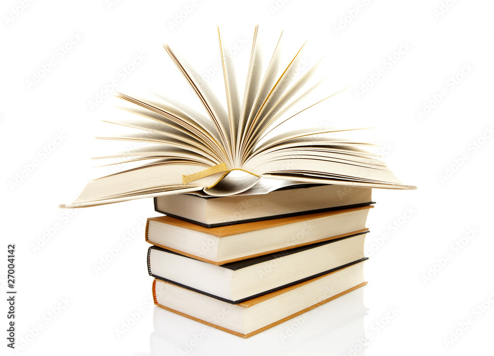 Fototapeta premium stack of books with open book over white background