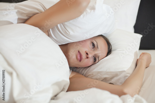 woman covered with pillow