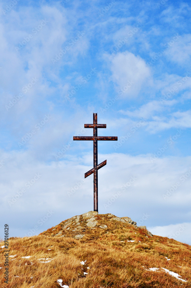 cross against the sky on high hill