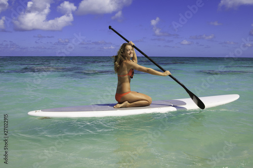 Canvas Print teenage girl in bikini on a paddle board in hawaii