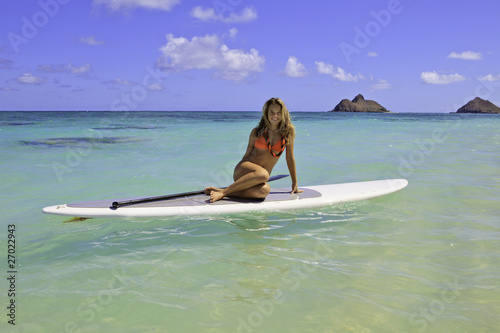 teenage girl in bikini on a paddle board in hawaii © tomas del amo