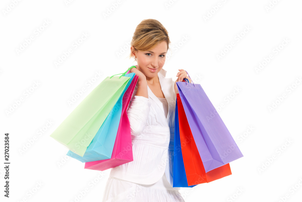 Young woman with shopping bags standing isolated on white