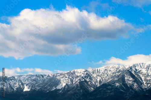 Winter mountains below blue cloudy sky © Mazur Travel