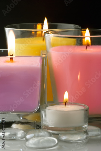 Decoration with colored burning candles and glass drops