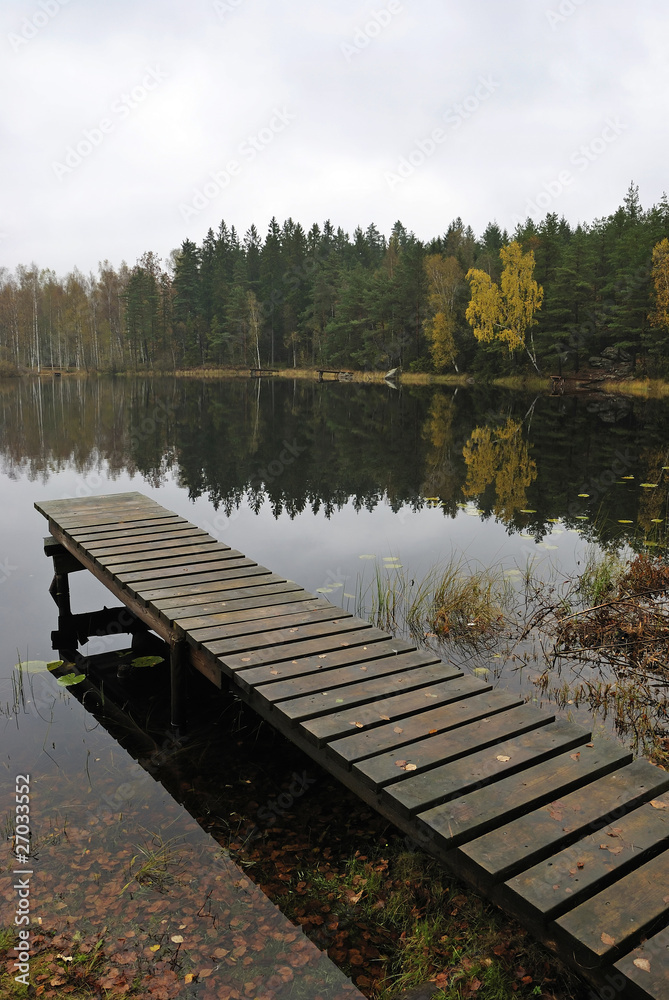 Traditional wooden Swedish bridge in rainy day