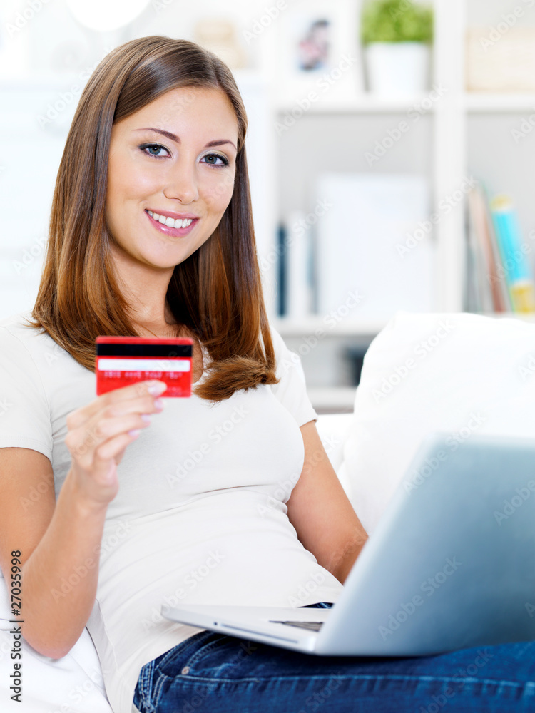 woman holding credit card with laptop woman holding credit card with laptop