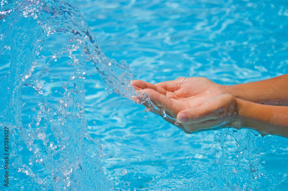 Female hands and water splashes