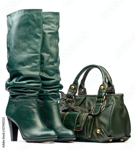Green female high-heeled boots and leather bag