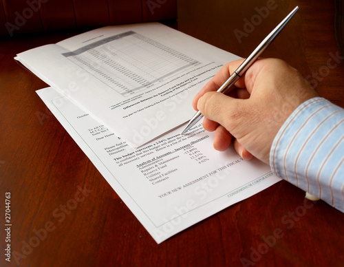 male hand with pen on the budget document