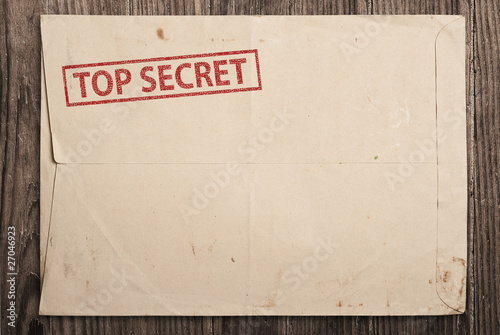 Open top secret envelope on table.