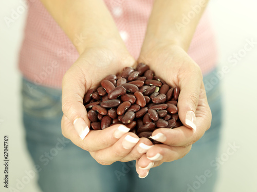 Young Woman With Handful of Kidney Beans. Model Released