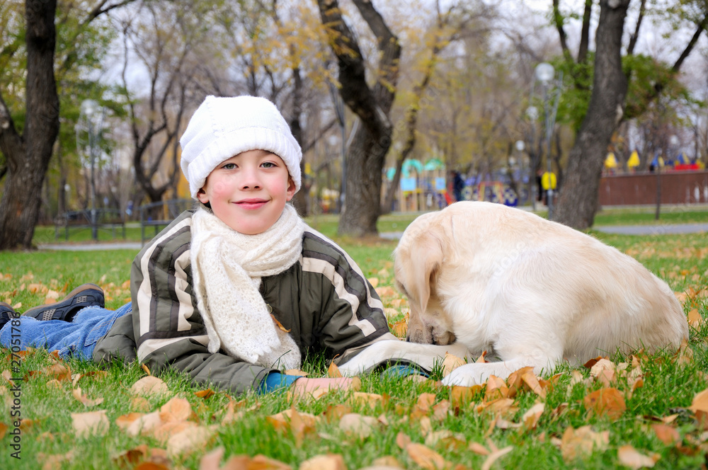 Boy playing in autumn park