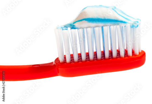 Red toothbrush with toothpaste on it