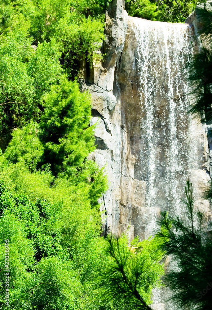 Tall waterfalls on the bright summer day