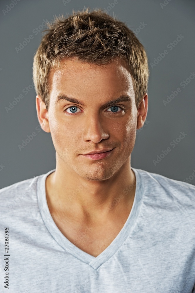 Fototapeta premium Close-up portrait of a young handsome man