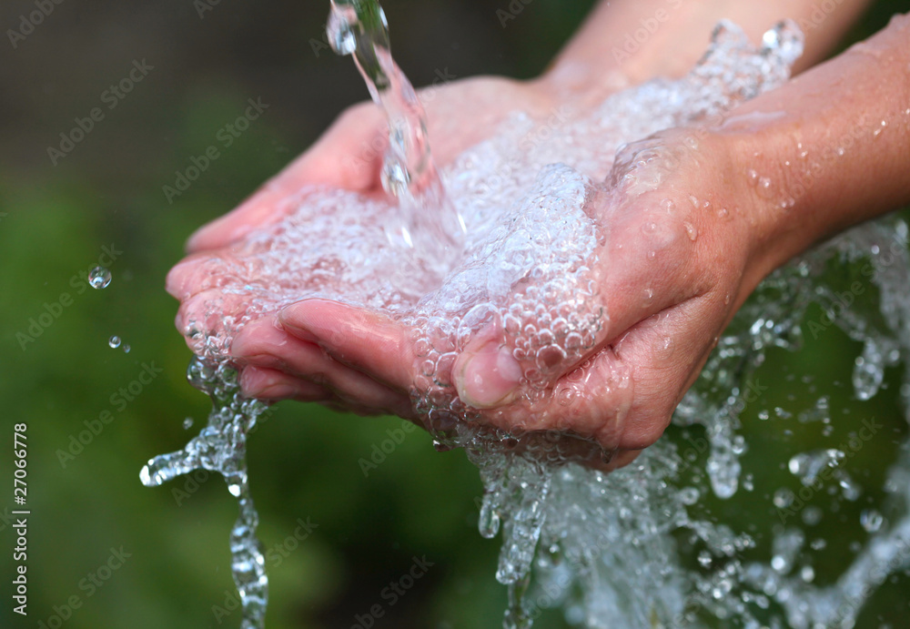 Fototapeta premium Woman's hands with water splash