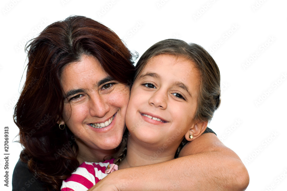 Latin mother smiling and hugging her small daughter on a white b Latin mother smiling and hugging her small daughter on a white b