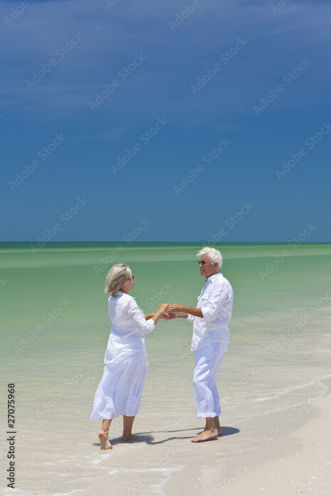 Happy Senior Couple Dancing Holding Hands on A Tropical Beach Happy Senior Couple Dancing Holding Hands on A Tropical Beach