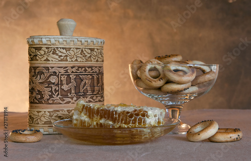 Still-life with ware and honey in honeycombs
