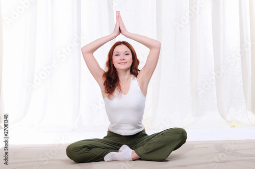 Young girl doing yoga exercises