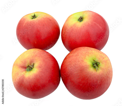 Four red apples with a green blush