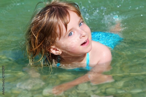 blond girl swimming in lake river