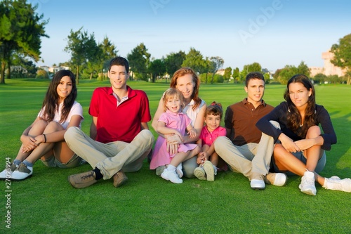 family friends group people sitting green grass