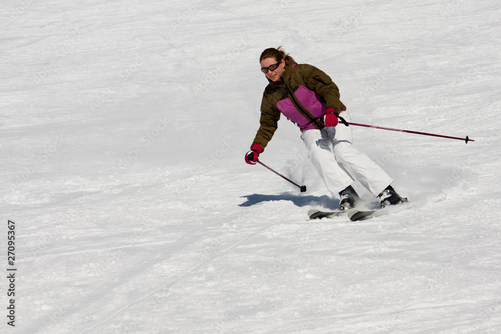 Woman downhill skiing on wide piste