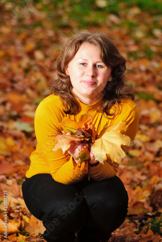 Woman in autumn leaves